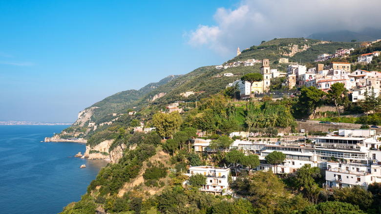 Buildings on a hillside next to the sea on the Italian coast.