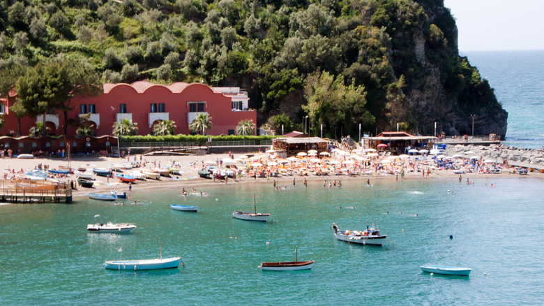 A sandy bay backed by a tall green hill in Vico Equense