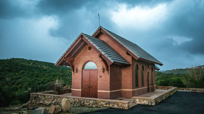 A brick chapel against the clouds of a coming storm
