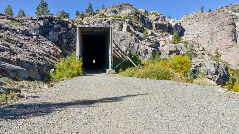 A tunnel entrance carved into a rocky mountain