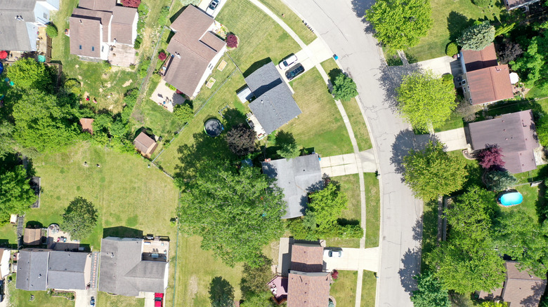An overhead view of a residential neighborhood with mowed lawns