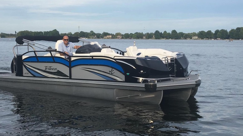 Man on pontoon boat on Morse Reservoir