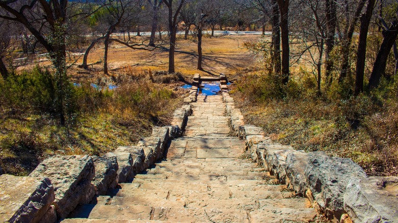 A stone staircase leads to a stream at Abilene State Park in Texas