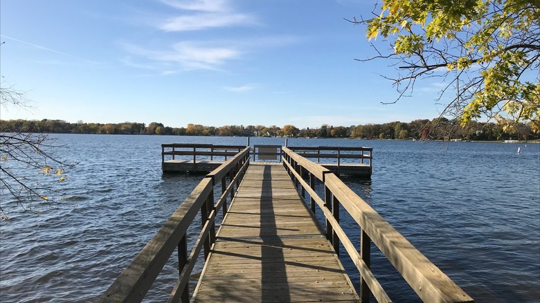 A wooden dock extending into the water at Lake Minnewashta Regional Park, Minnesota