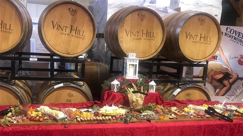 charcuterie spread set up in front of a stack of wine barrels at Vint Hill Craft Winery
