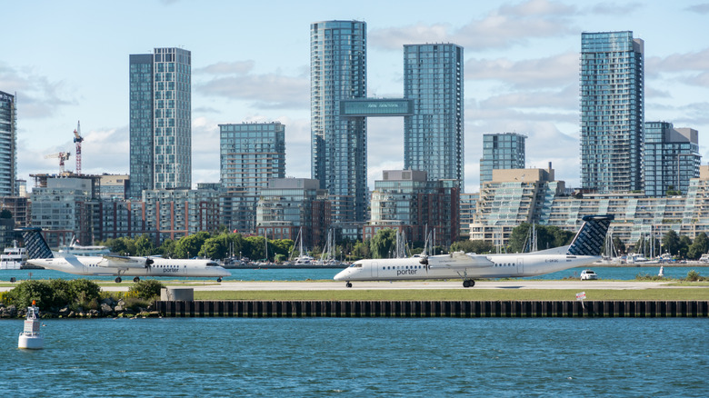 Two planes on the runway at Billy Bishop Airport, Toronto, Canada
