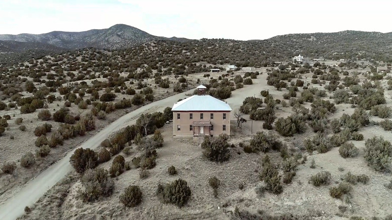 Aerial view of historic building on hill in White Oaks, NM