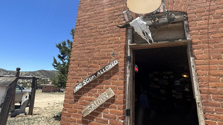 Entrance door and exterior signs at No Scum Allowed Saloon