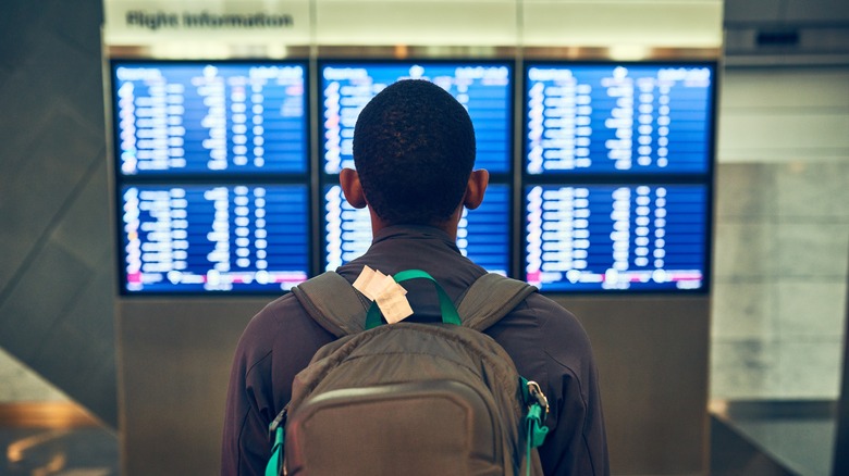 A man checks flight information in an airport