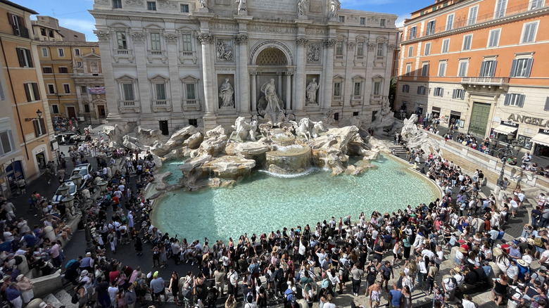 Top view of crowds of tourists around Trevi Fountain