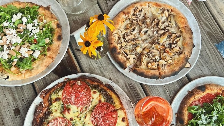 Overhead shot of pizzas and drinks at The Laundrette