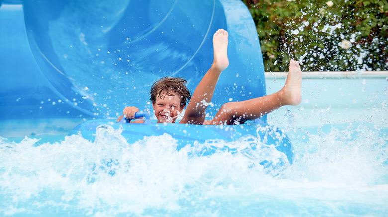 A child on a waterslide at a water park, New York