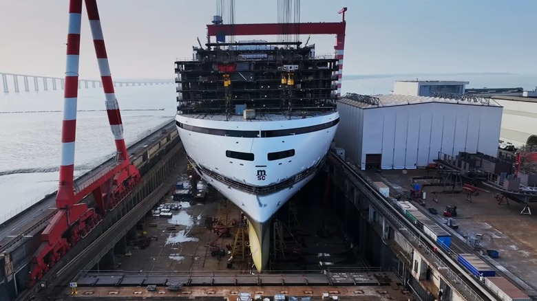An MSC cruise ship being constructed at a shipyard.