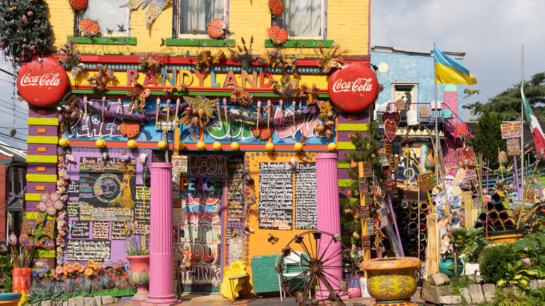 vibrant colors on a yellow building with pink columns and items around