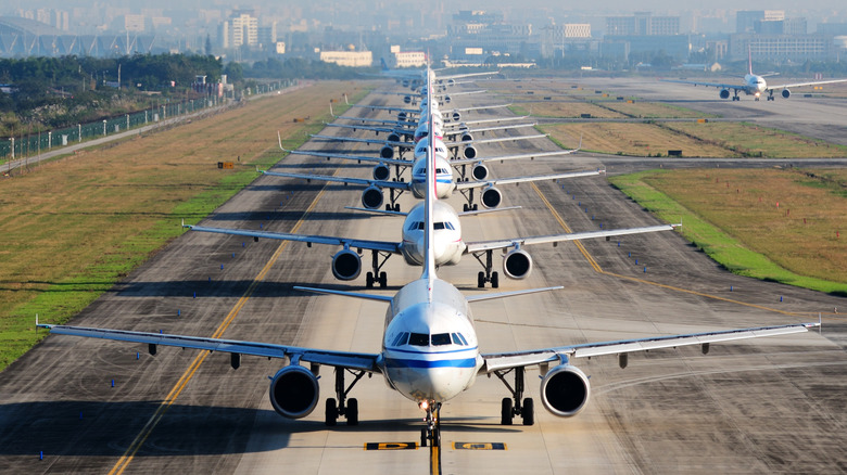 Planes lined up on a runway