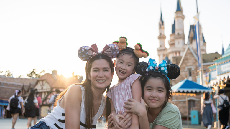 A family posing at a Disney theme park