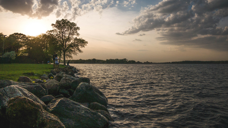 Lake Minnetonka with a rocky shoreline and people fishing