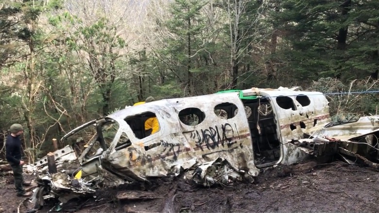 Graffiti-covered wreckage of a aircraft wreck in a forest