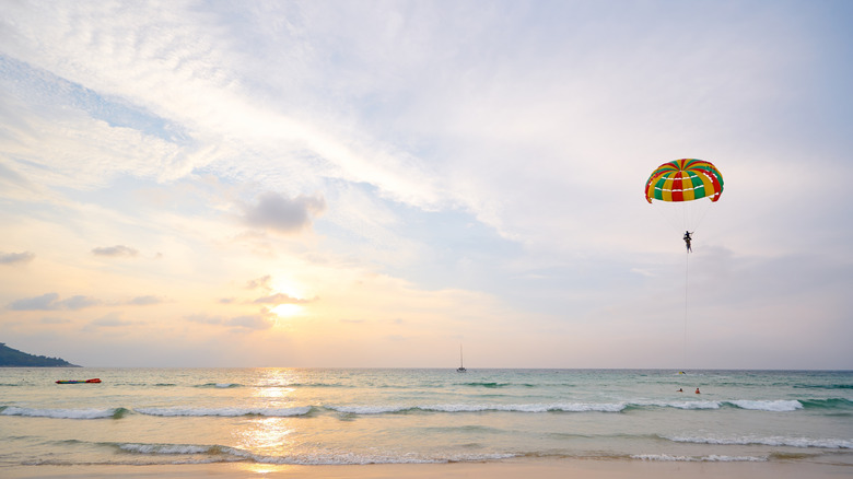A parasailor soars above the beach