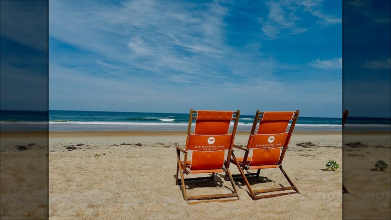 Two Sanderling beach chairs near the water