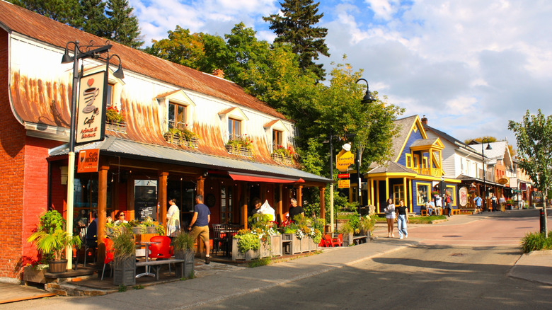 A small town street lined with cafes and shops
