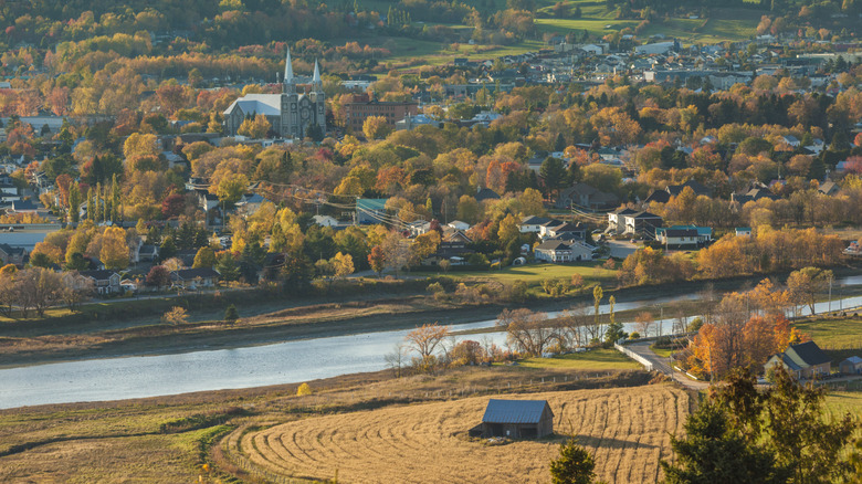 A quaint small town in fall with a river running through it