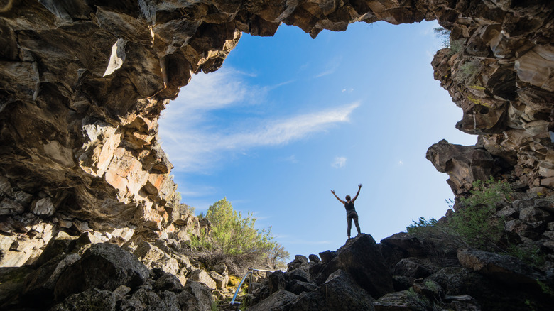 Person standing in a cave in Lava Beds National Monument, Modoc County, California