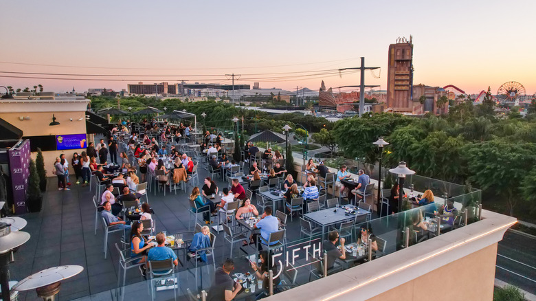 Patrons overlooking Disneyland from The Fifth rooftop