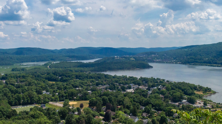 Trees look over water under blue cloudy sky in Hudson Valley