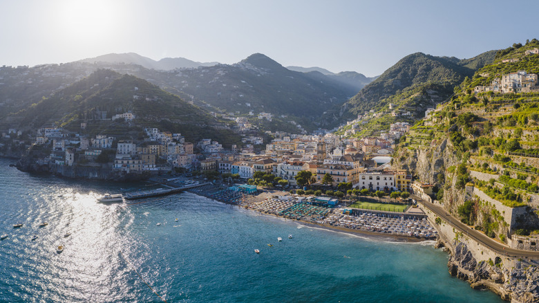 Colorful buildings line Mediterranean cliffs