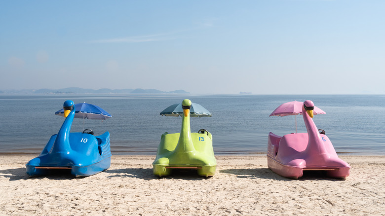 Colorful swan paddle boats at a beach on Ilha de Paqueta, Brazil