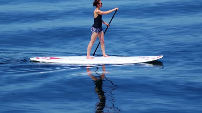 A woman paddleboarding on Lake Washington in Seattle