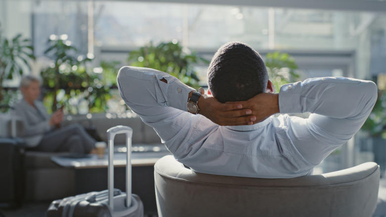 Airport traveler relaxes in a lounge before flight.
