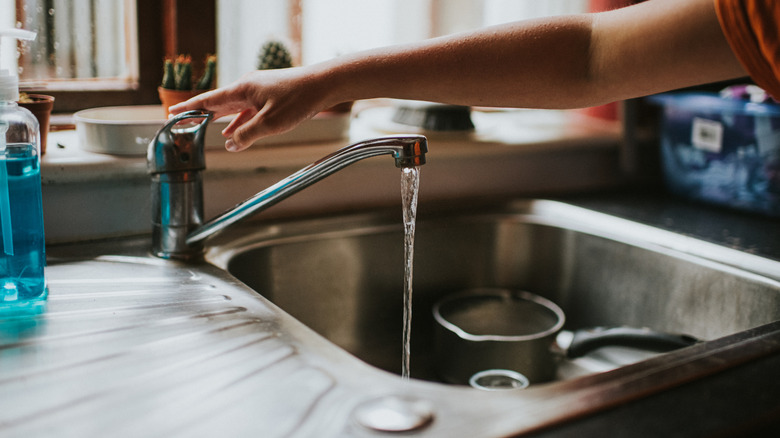 Sink in the kitchen with water running