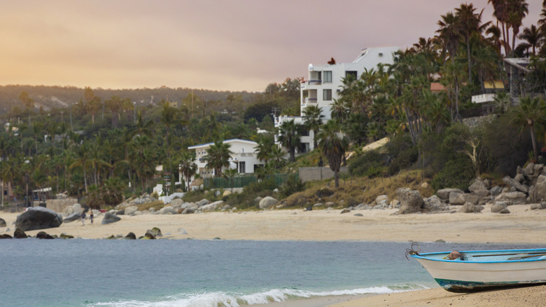 Beach backed by jungle with white houses in Los Barriles, Mexico