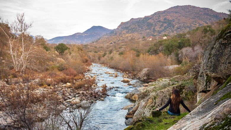 a woman next to the river in Three Rivers