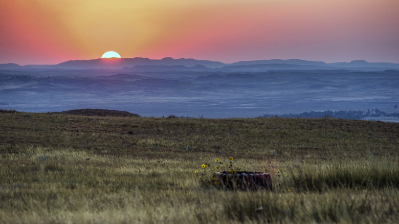 Sunset over hills, mountains, and fields in Wyoming's Eastern Plains.