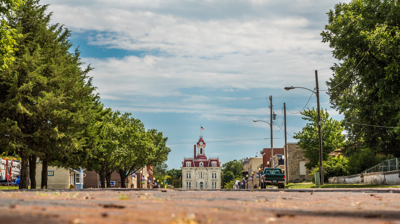 The Chase County Courthouse, a French Renaissance-style limestone building with a red roof, in Cottonwood Falls, KS