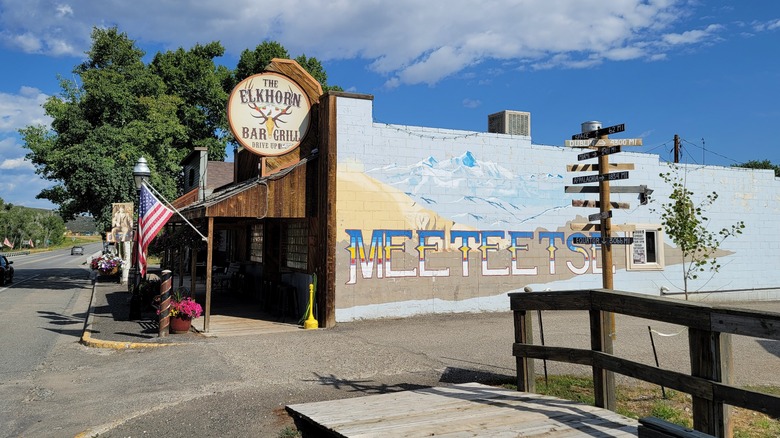 Downtown main street of Meeteetse, Wyoming showing a mural and rustic bar