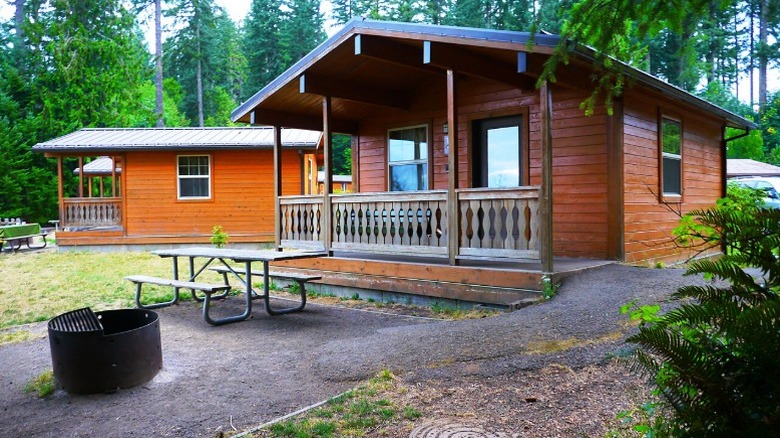 A wooden cabin with fire pit and patio at L.L. Stub Stewart State Park, L.L. Stub Stewart State Park
