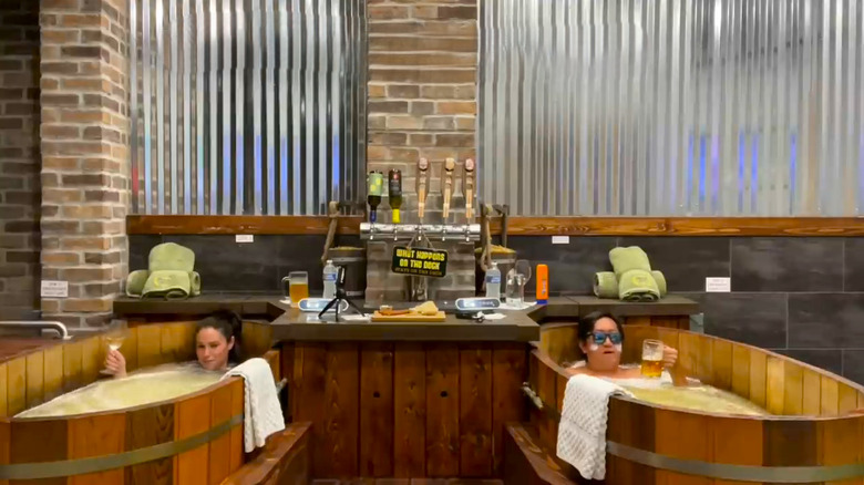 Man and woman soaking in beer tubs at My Beer Spa Orlando, FL