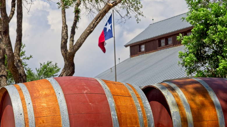 Wine barrels with Texas flag in background