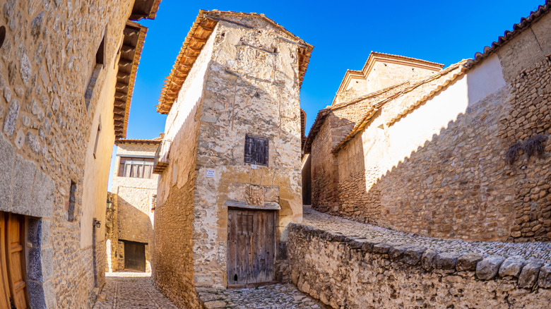 a scenic stone street in the rural Spanish village of Mirambel.