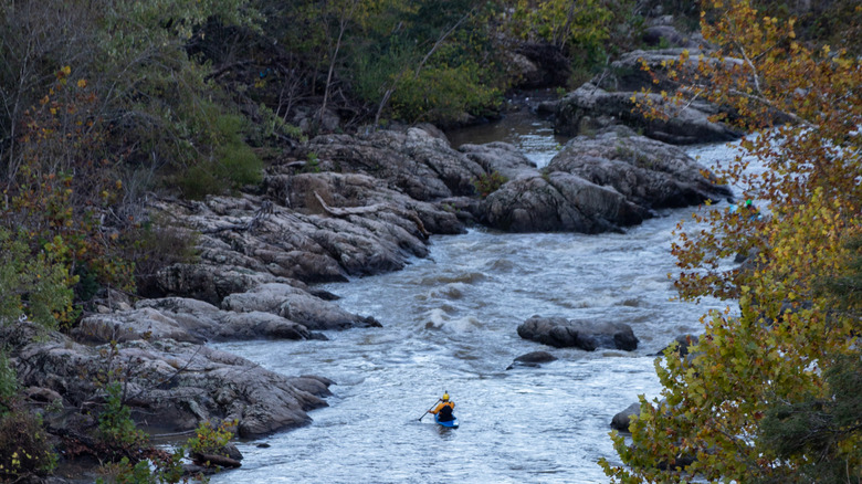 Person kayaking solo in Roanoke River's rapids