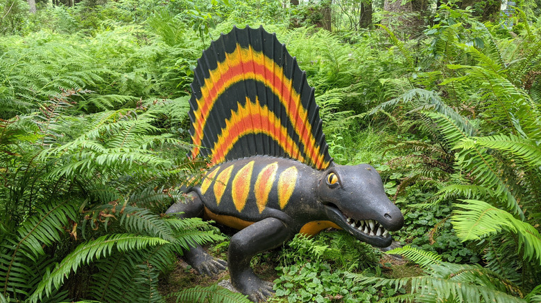 a dinosaur structure with forest backdrop at Prehistoric Gardens, Oregon