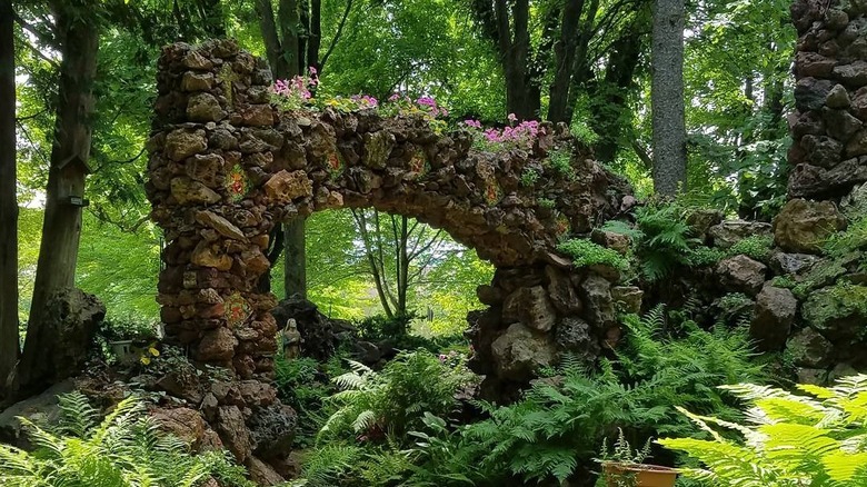 A stone arch surrounded by plants at the Rudolph Grotto Gardens, Wisconsin
