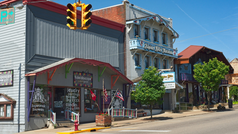 Main Street in Sugarcreek lined in buildings with Alpine-style facades under a blue sky