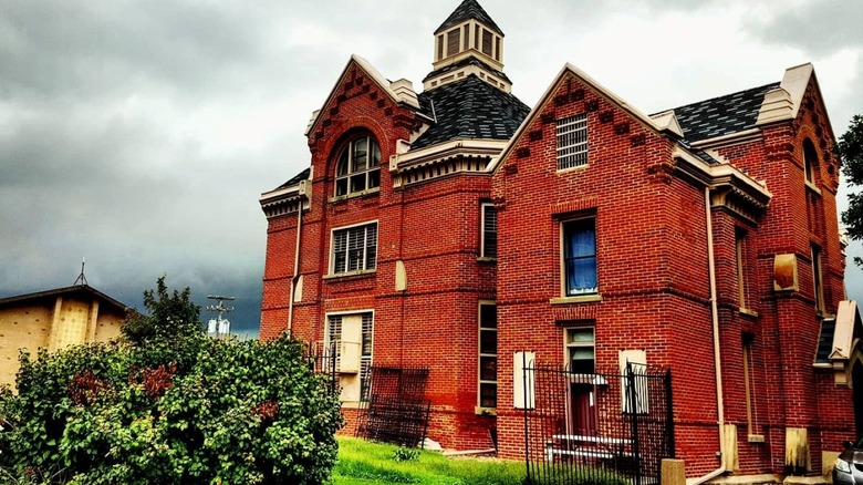 outside of Squirrel Cage jail on a cloudy day building