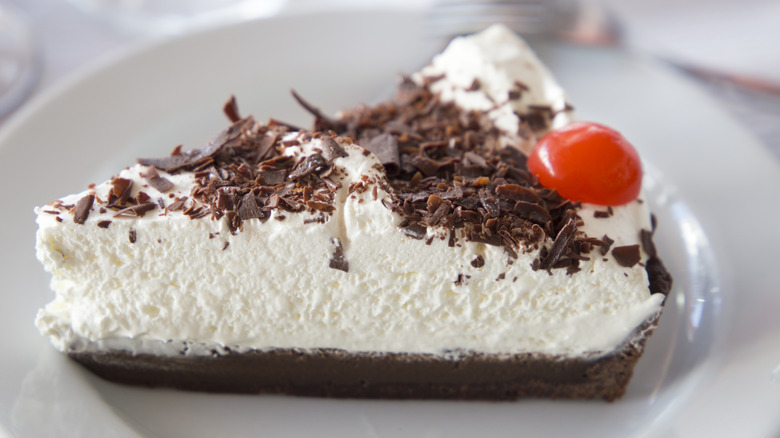 whipped cream and chocolate pie with cherry on top