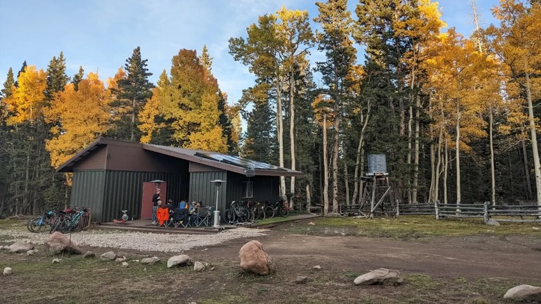 Fall colors frame a hut made of shipping containers